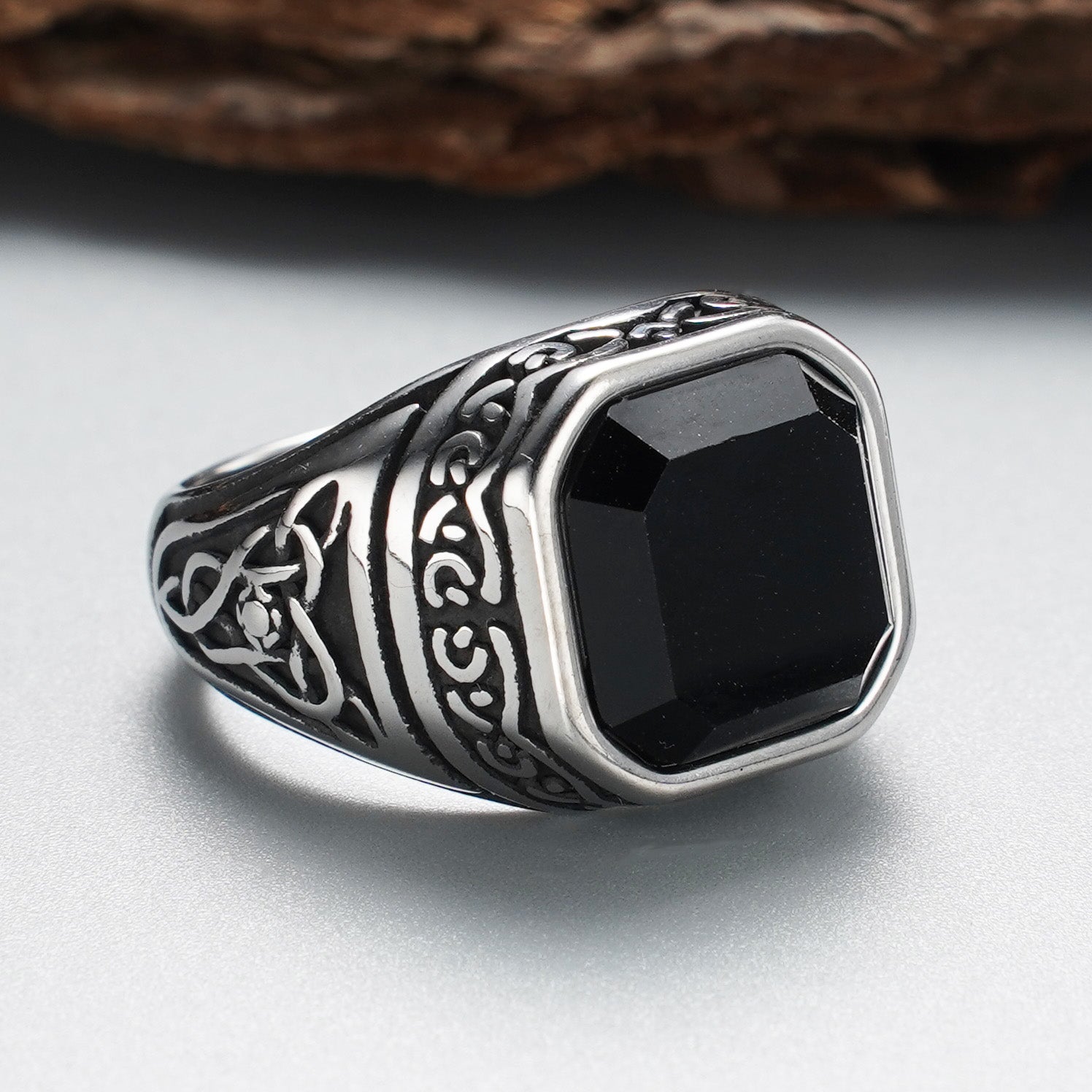 Men's stainless steel ring with black synthetic stone - front angle view